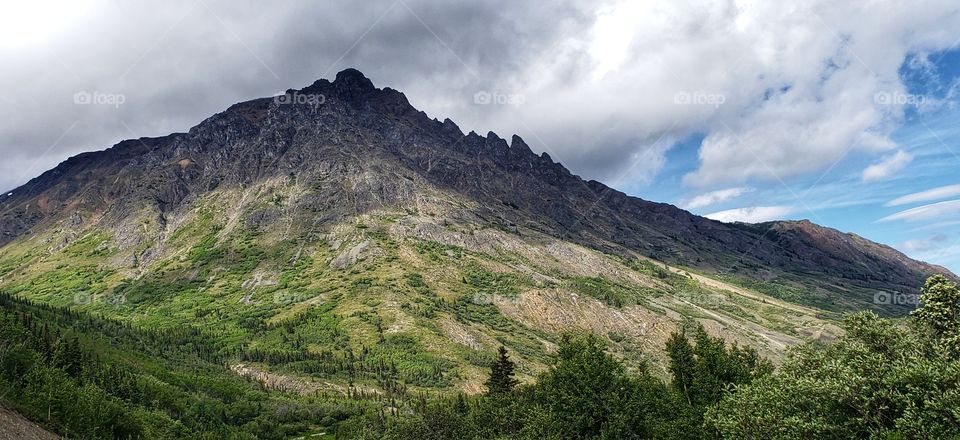 Shadows over green spring mountain tops