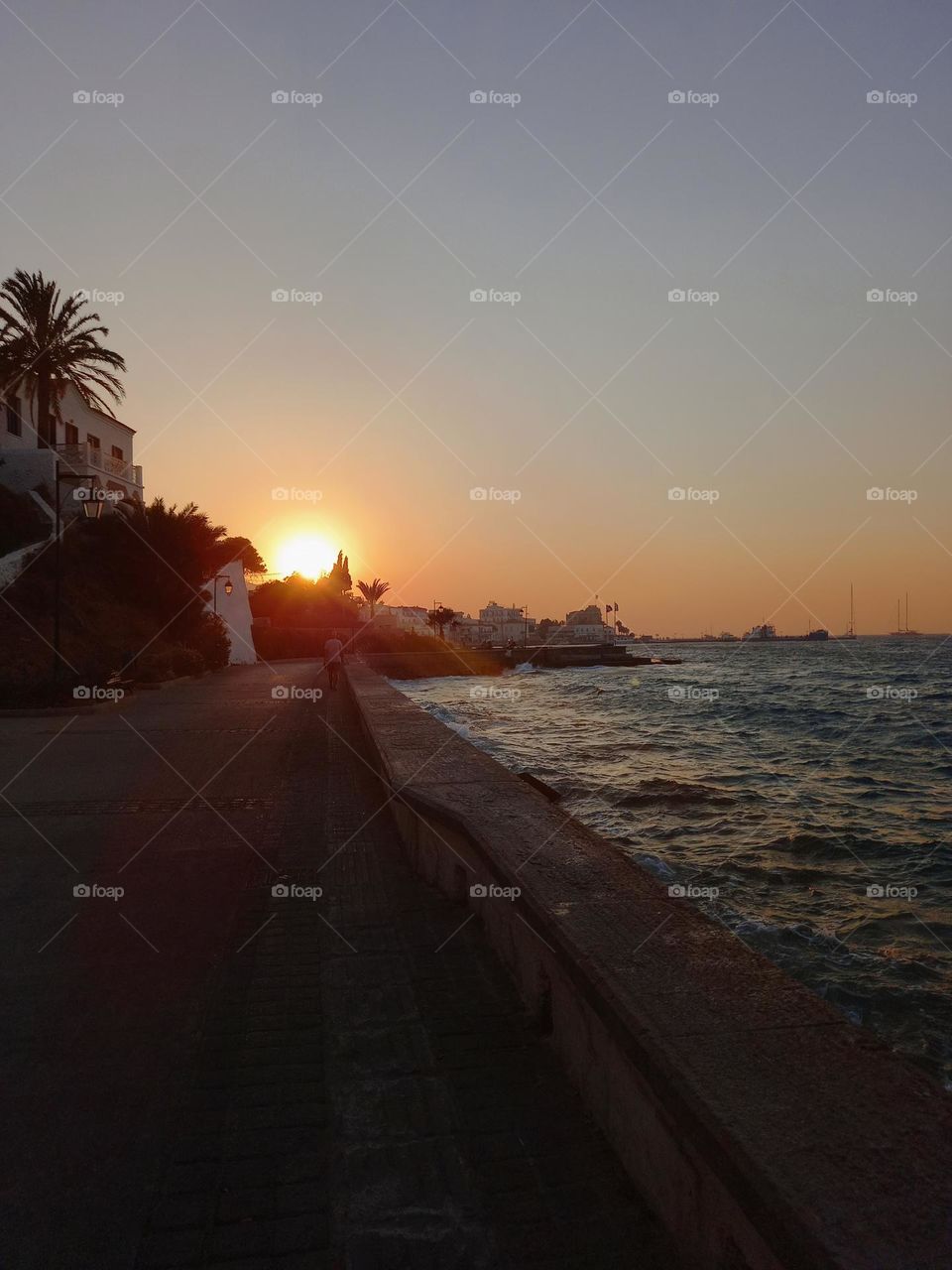 An evening walk next to the sea in Spetses, Greece. A magnificent view of the port, going around the walking paths of the island.