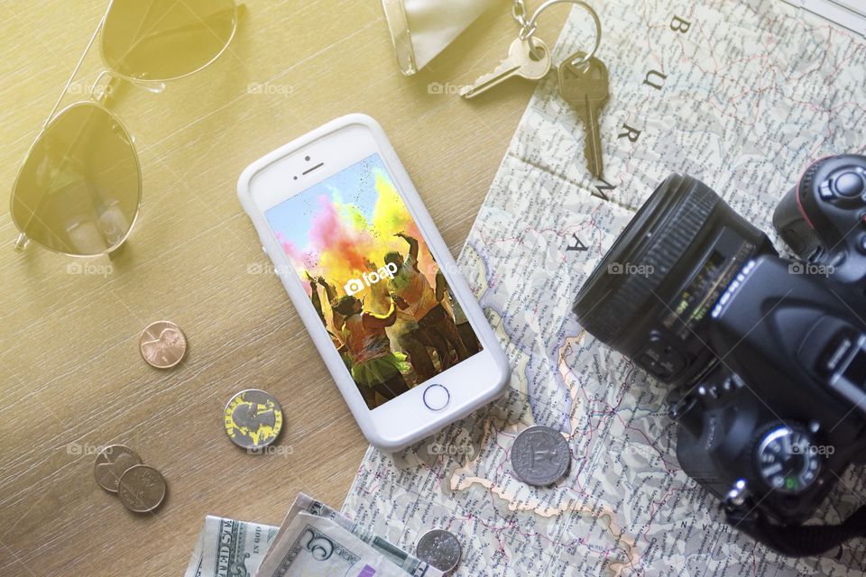 Foap layout with money keys travel map camera and sunglasses to express the app in a creative way for advertising