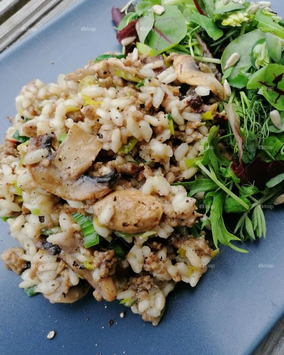 Mushroom risotto made at home! Risotto with rice, ground beef, fresh mushrooms, spring onions and fresh green salad. It's really good!