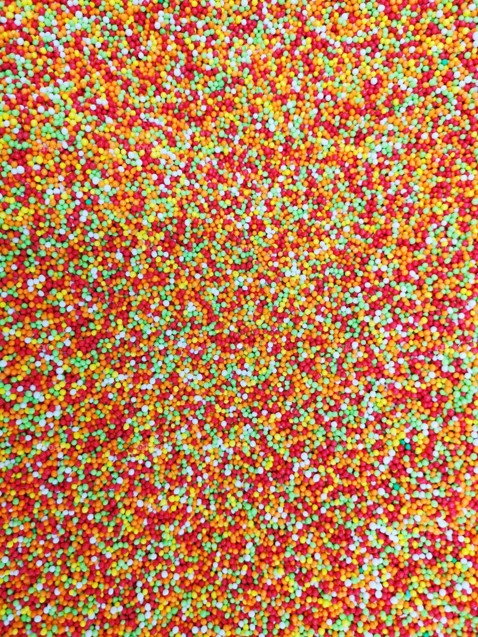 Multicolored little candies as background