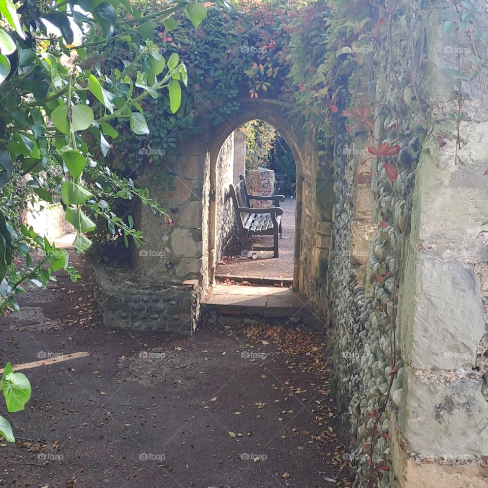 shadowy pathway to arch doorway on ancient building. u.k