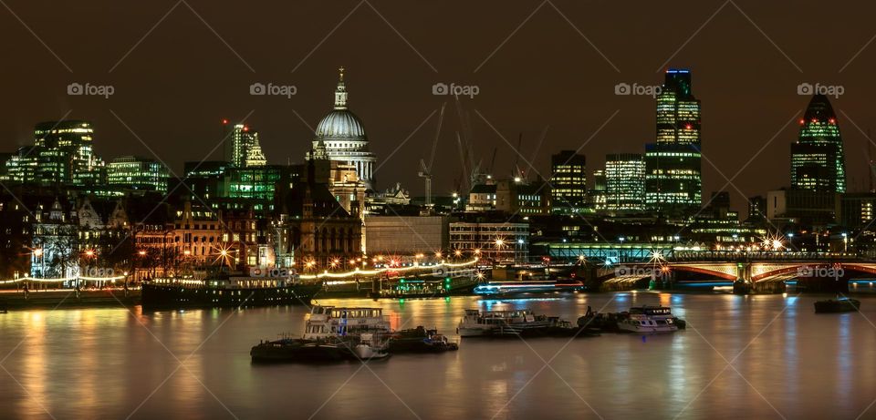 Old & new architecture dominates the city skyline viewed from Waterloo Bridge in London at night