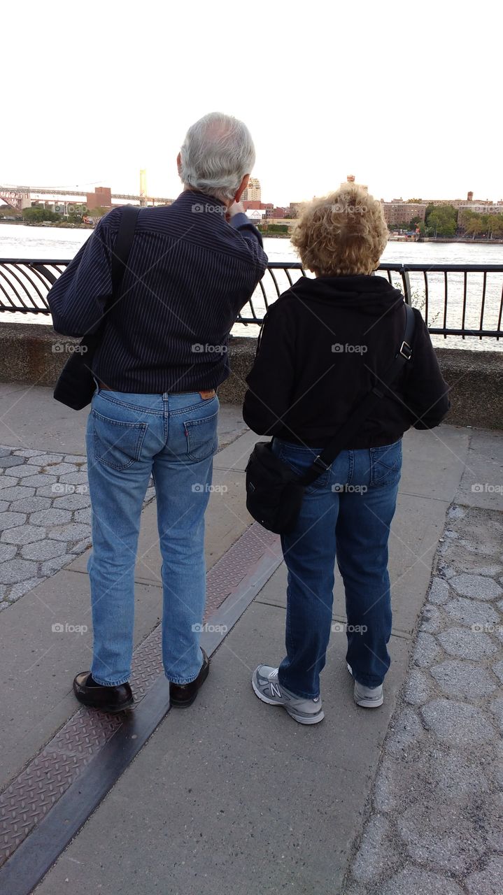 Elderly Couple from Behind looking out  at East River NYC