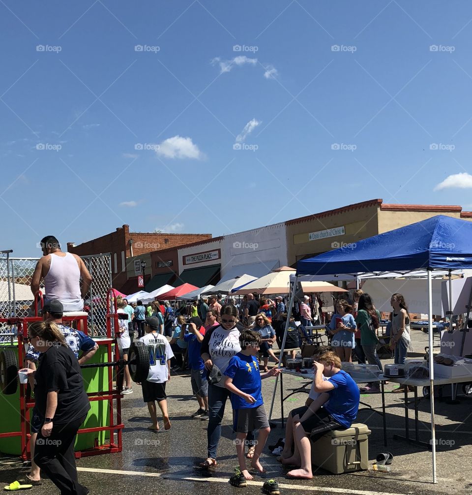 Spring festival in the south with colored umbrella tops and crowds milling about. 