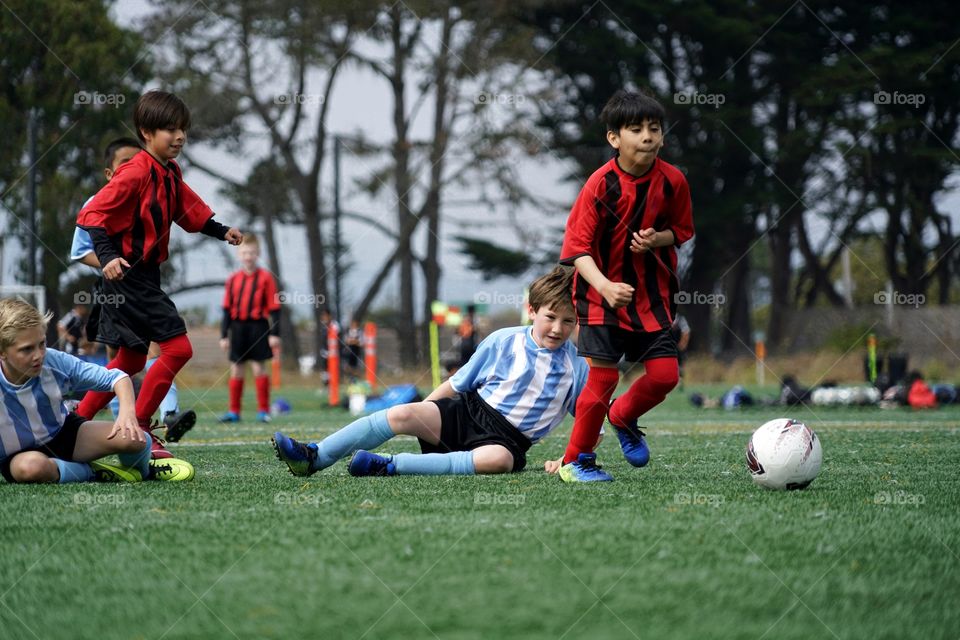 Boy Falling Down Playing Soccer