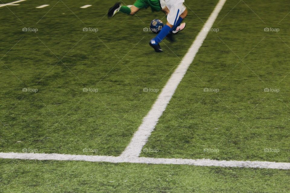 Indoor soccer. Boys running with the ball 