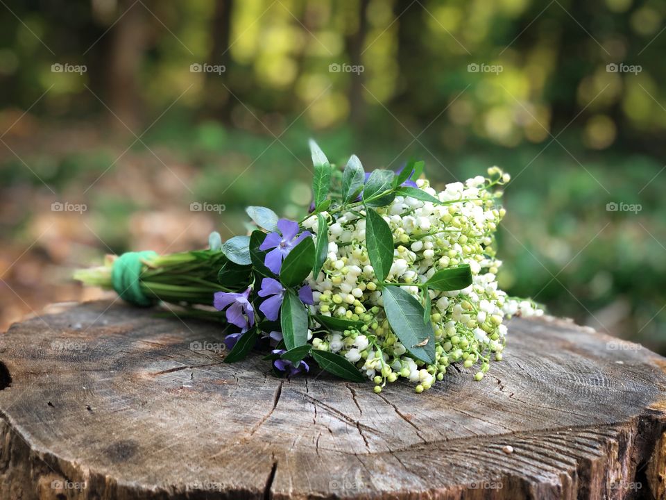 Spring bouquet of lily of the valley and purple flowers 