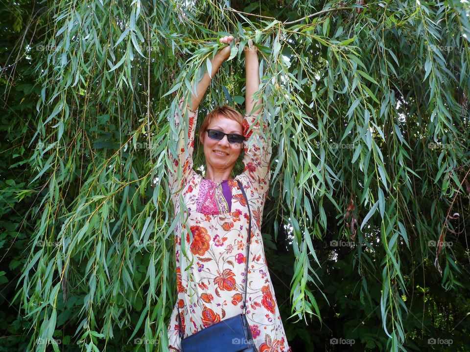 portrait of a girl with glasses on a background of foliage