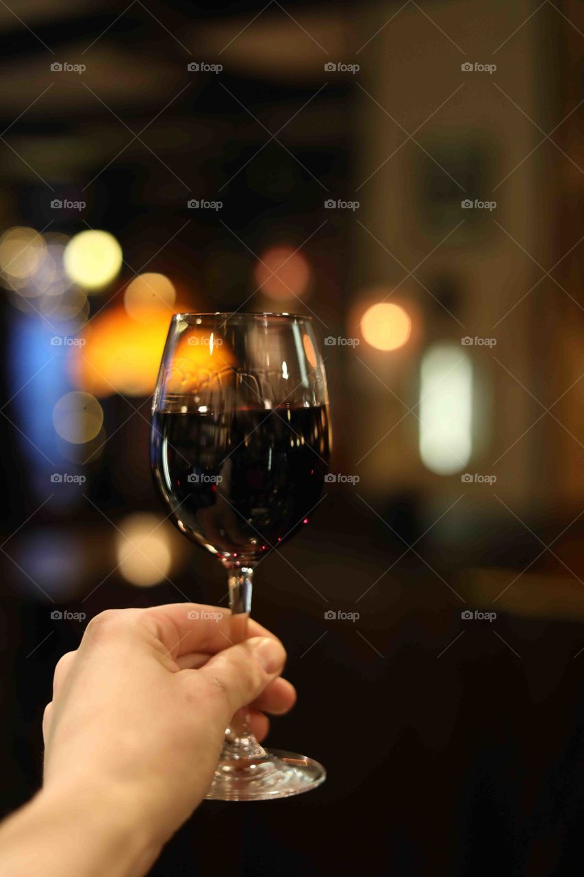 A glass of red wine in a hand