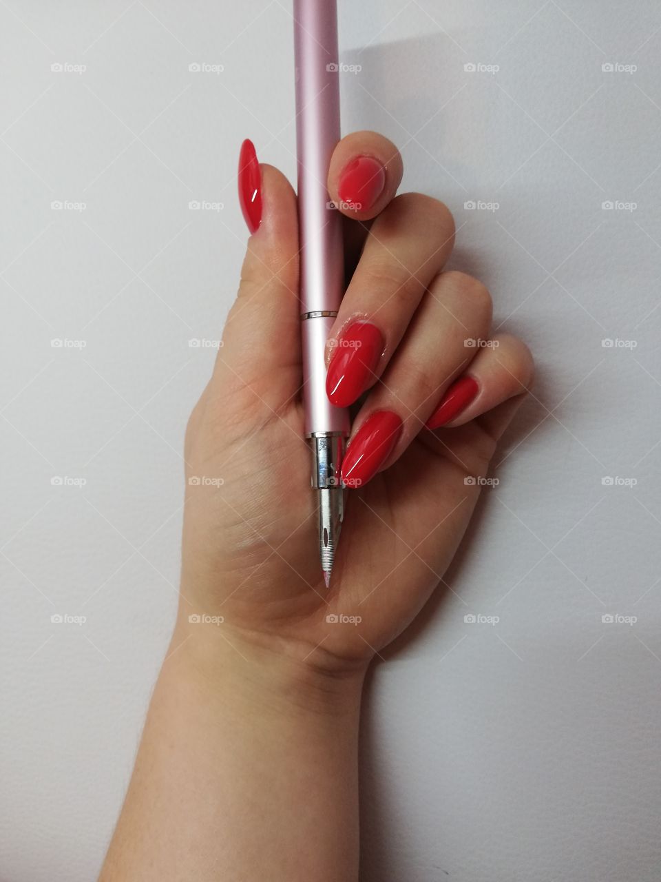 Long, red nails with stylograph