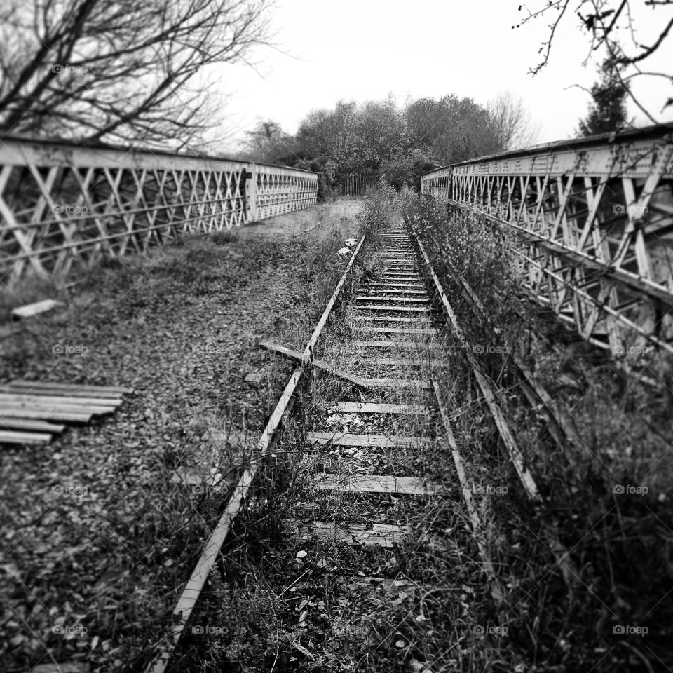 Abandoned railway bridge over the canal in Watford, England UK