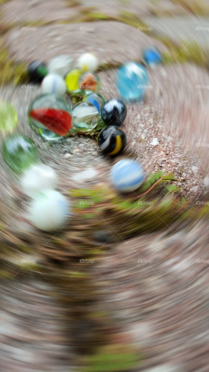 Colorful marbles. Close-up of colorful swirling marbles on outdoor brick patio