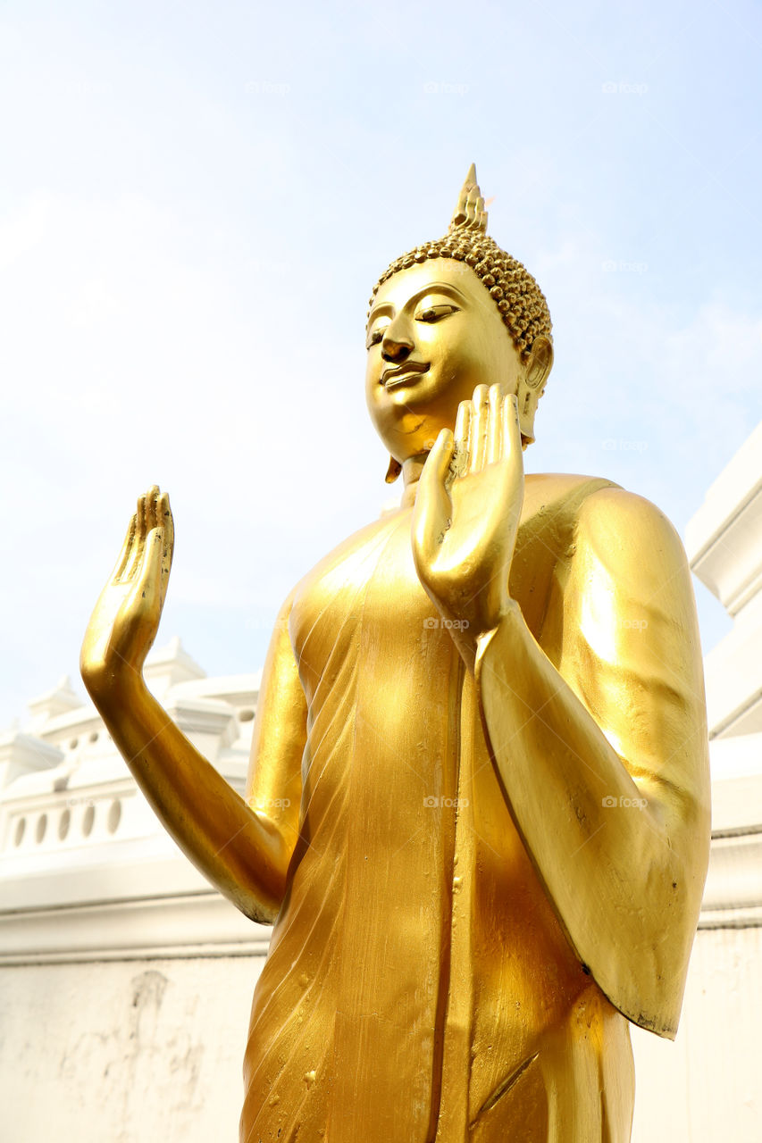 Golden buddha​ statue in Buddhism Temple.