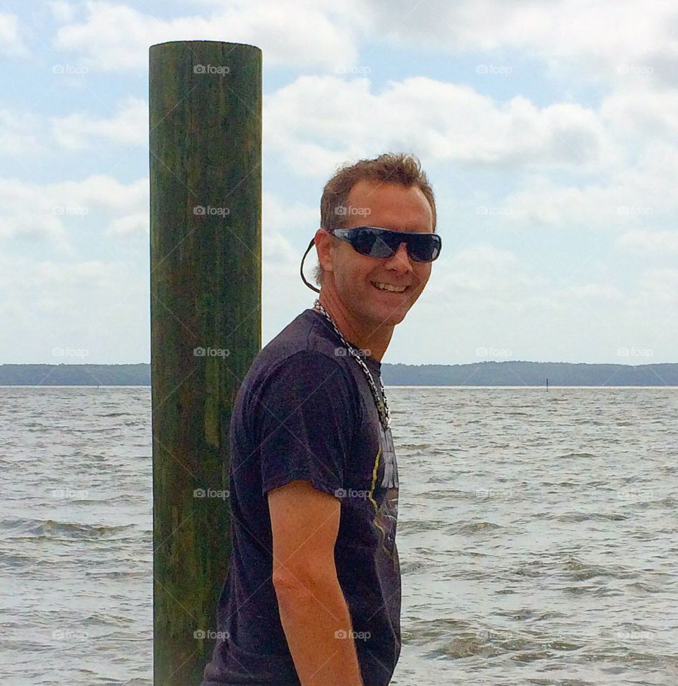 Smiling man near the sky