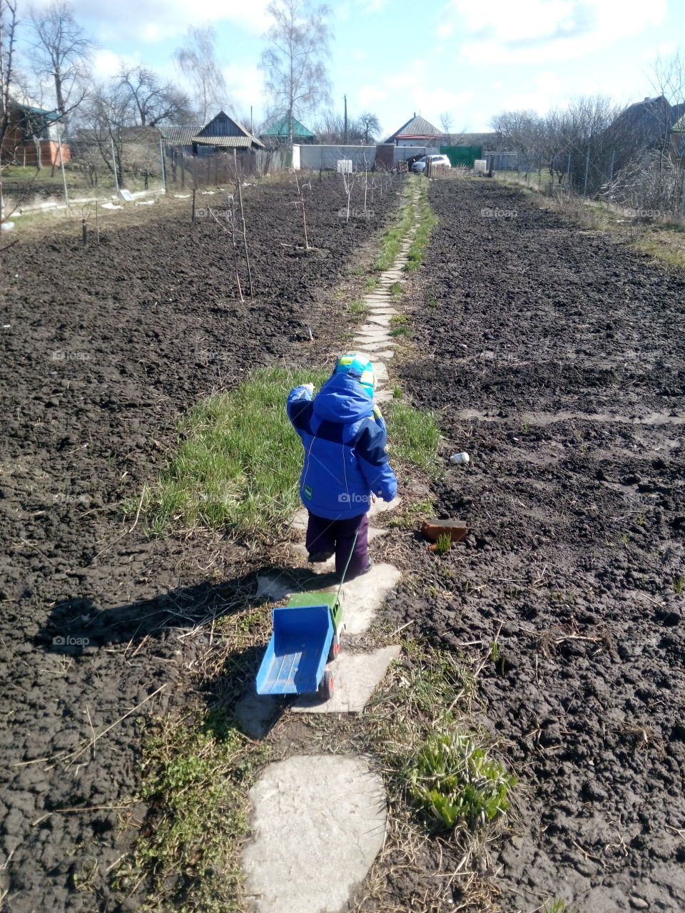 boy and toy in a road farm