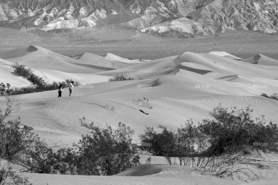 A couple in the distance exploring the sand dunes of Death Valley National Park in the month of March!