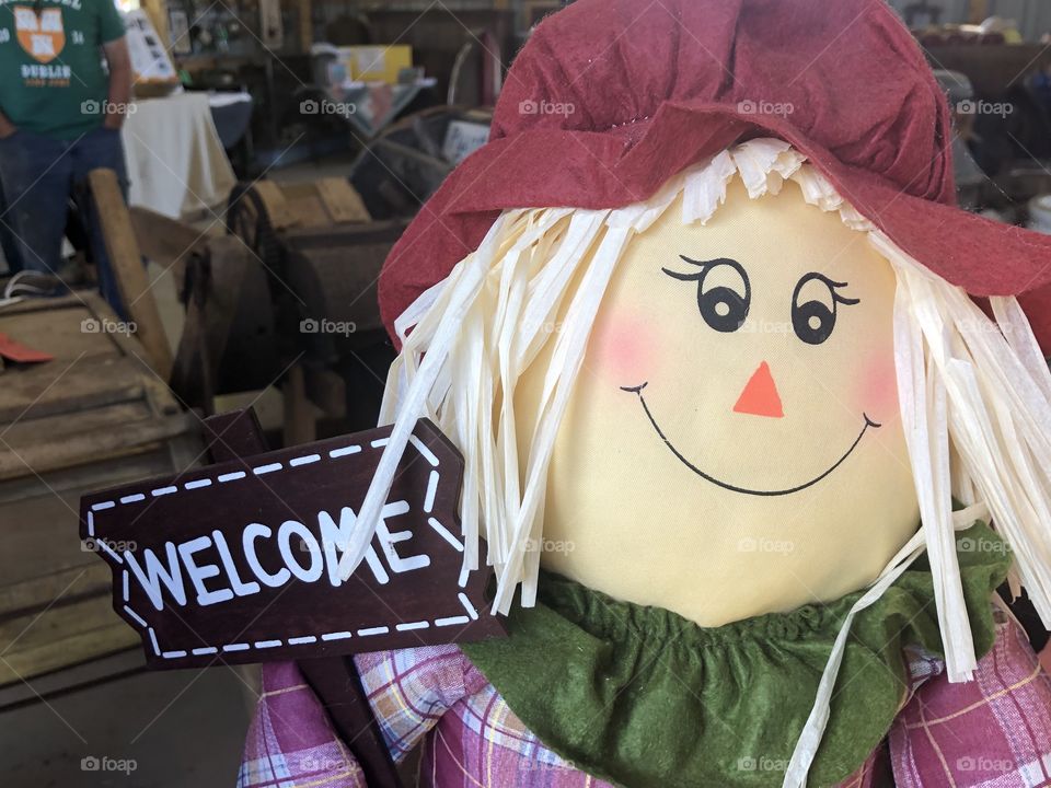A smiling welcome scarecrow