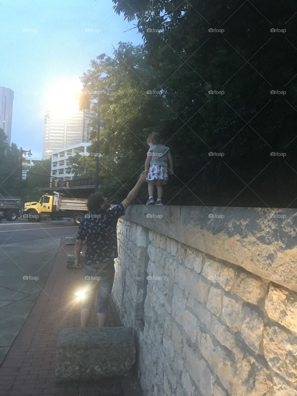 Independence Day celebration with daddy and daughter walking along a wall