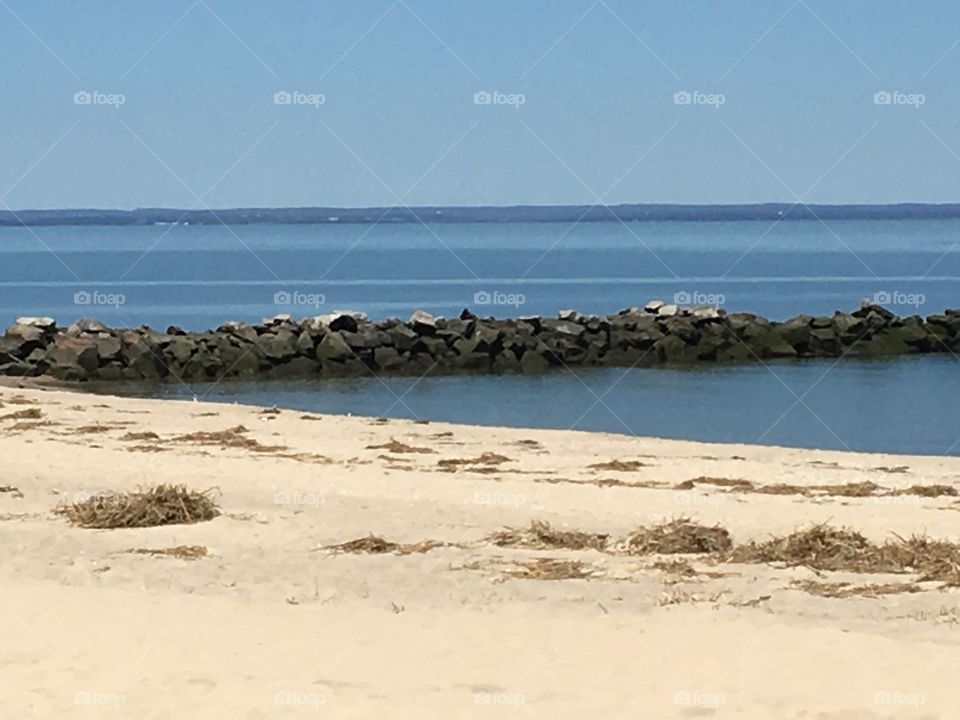 A photo of a Beautiful rock peer on the beach.