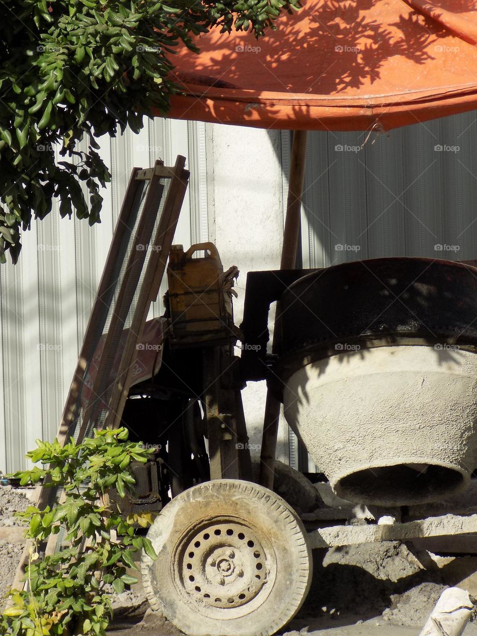 Cement mixer under tarpaulin