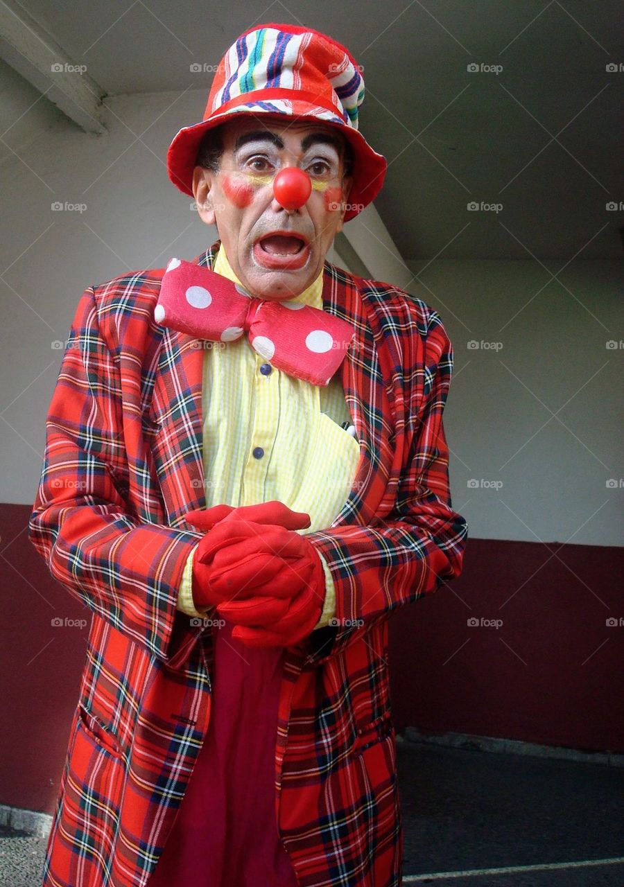 Cuban clown, full red, pink, and magenta full dress. Very expressive