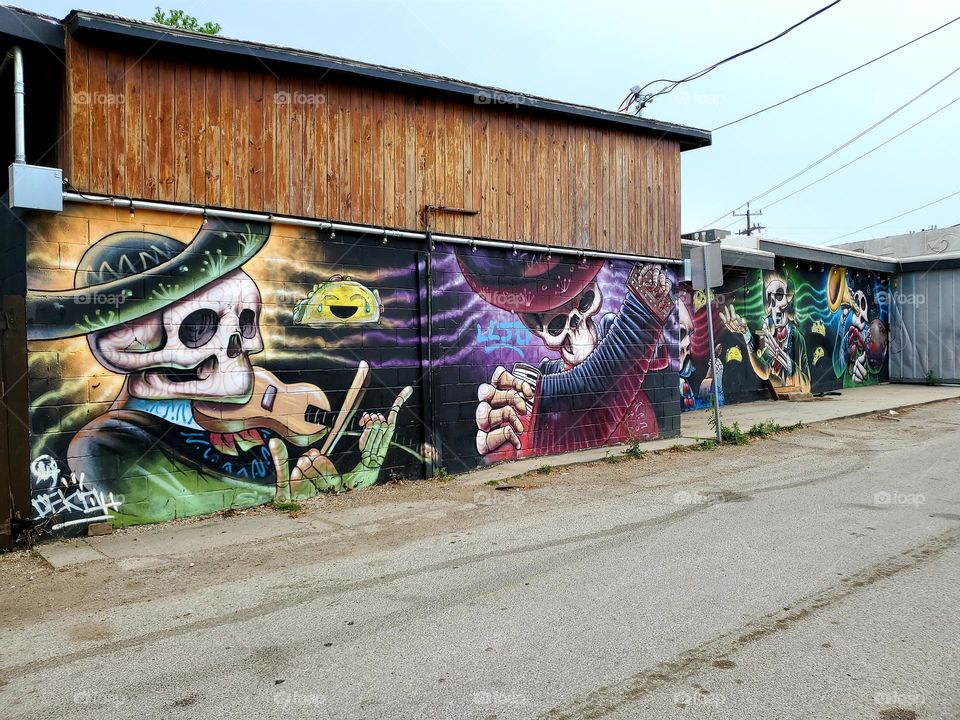 Street art celebrating Dia de los muertos/  Day of the dead.  A Mexican cultural tradition of celebrating and remembering those that have passed. The art features a band of dead musicians playing music together.