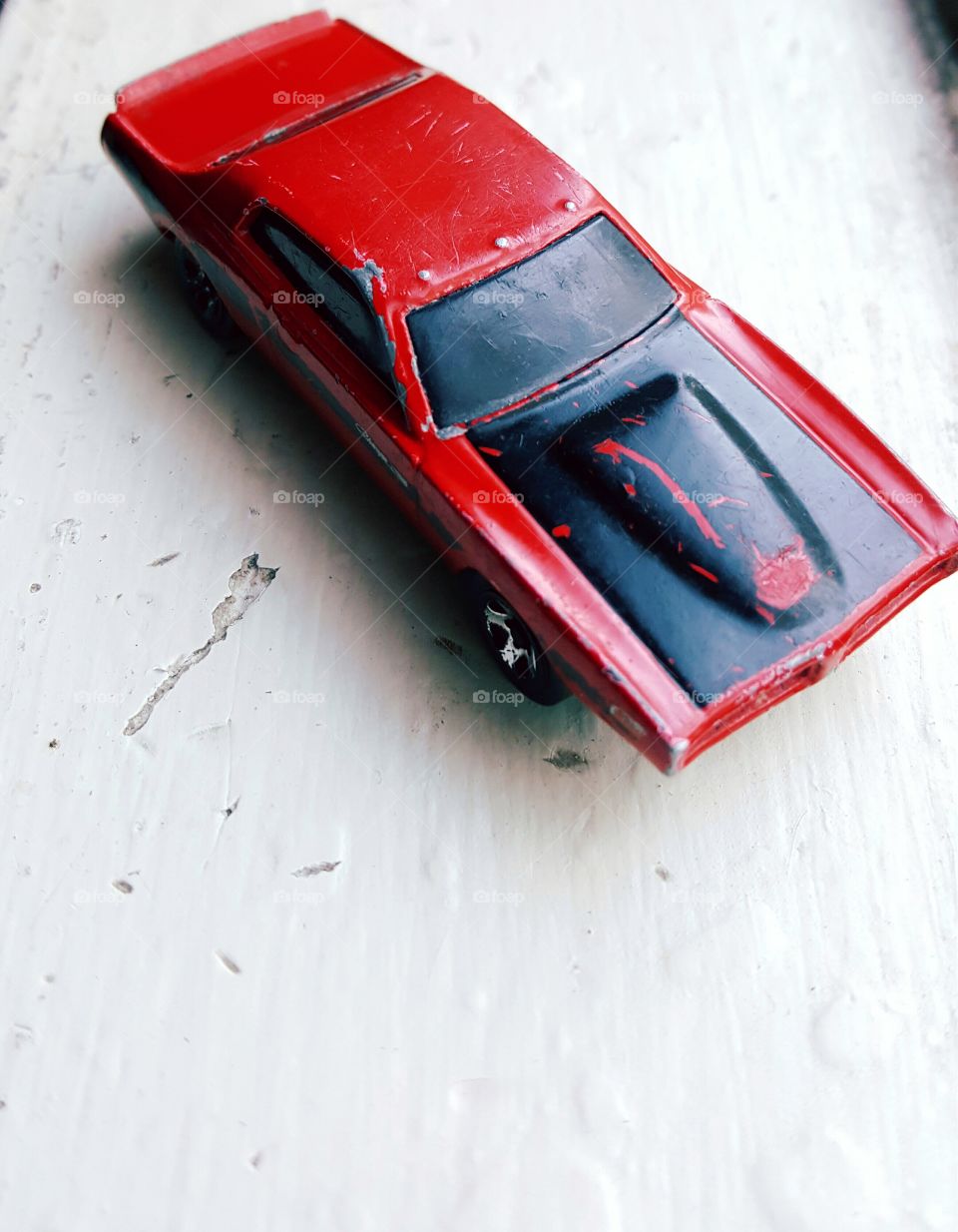 red toy car on windowsill