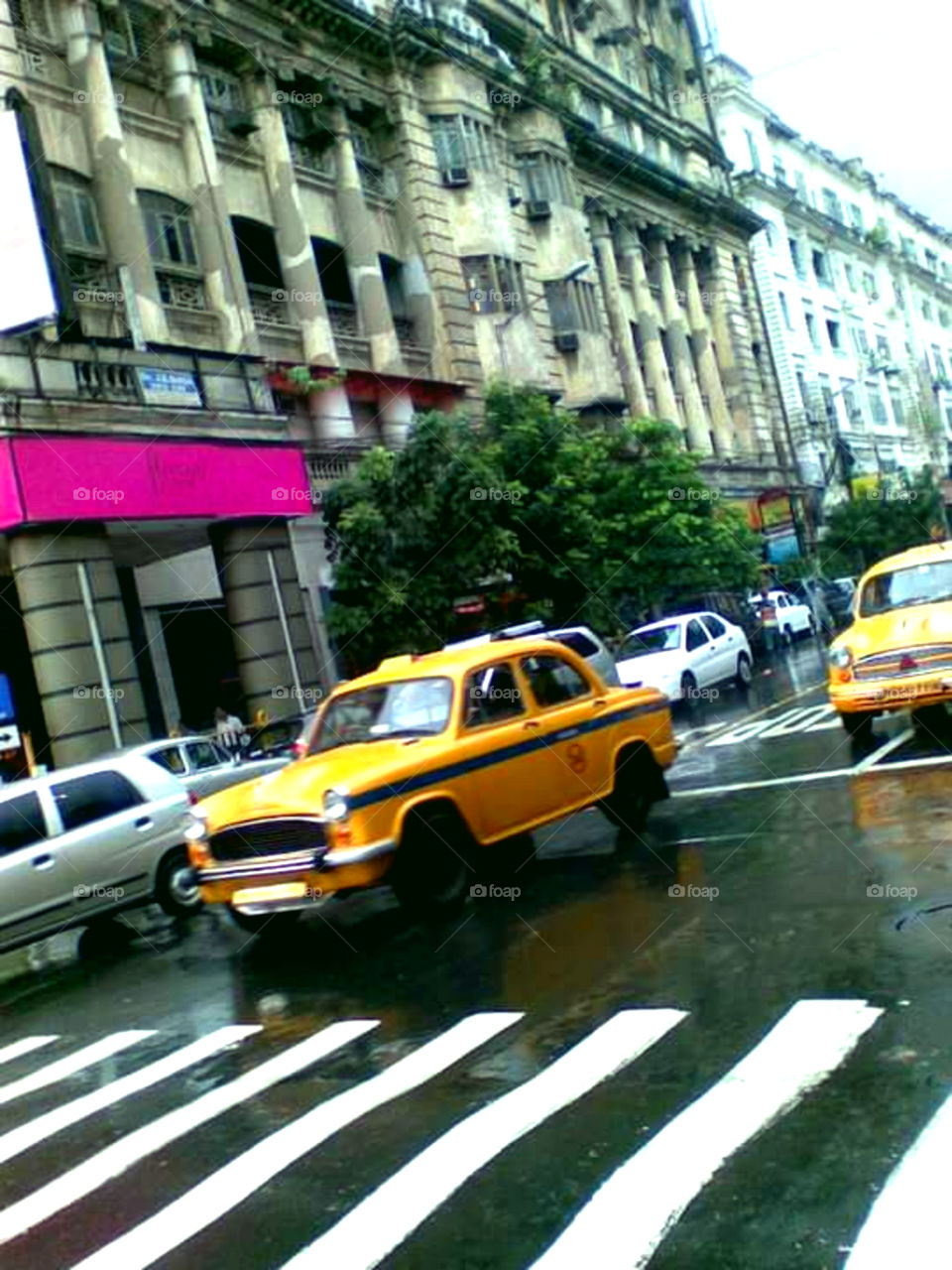 Yellow Cab on busy Street.