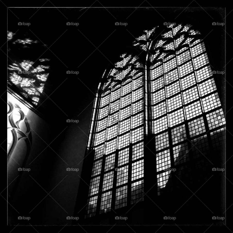 A church window with shadow on wall