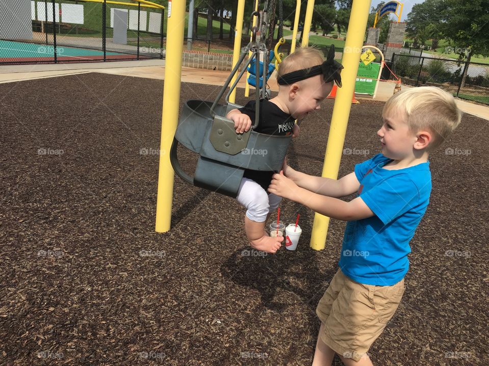 Kids having fun on swings at playground