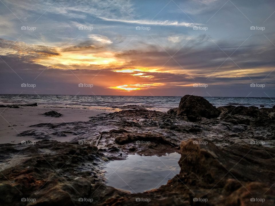 sunset from behind a rock