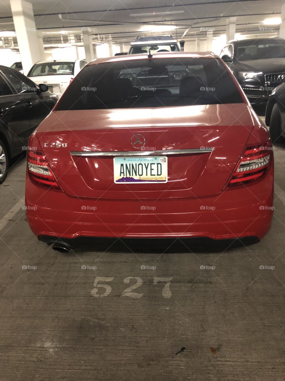 Funny license plate on a car in a parking garage