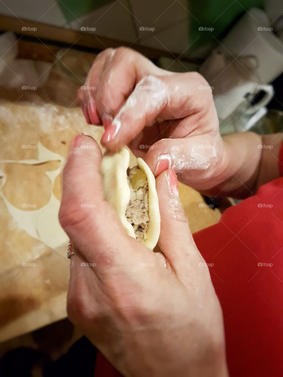 A person preparing pierogi