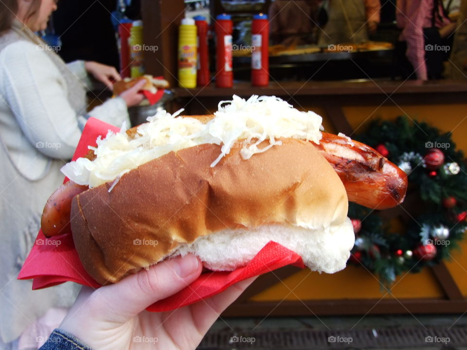 Holding a German sausage with sour kroaut