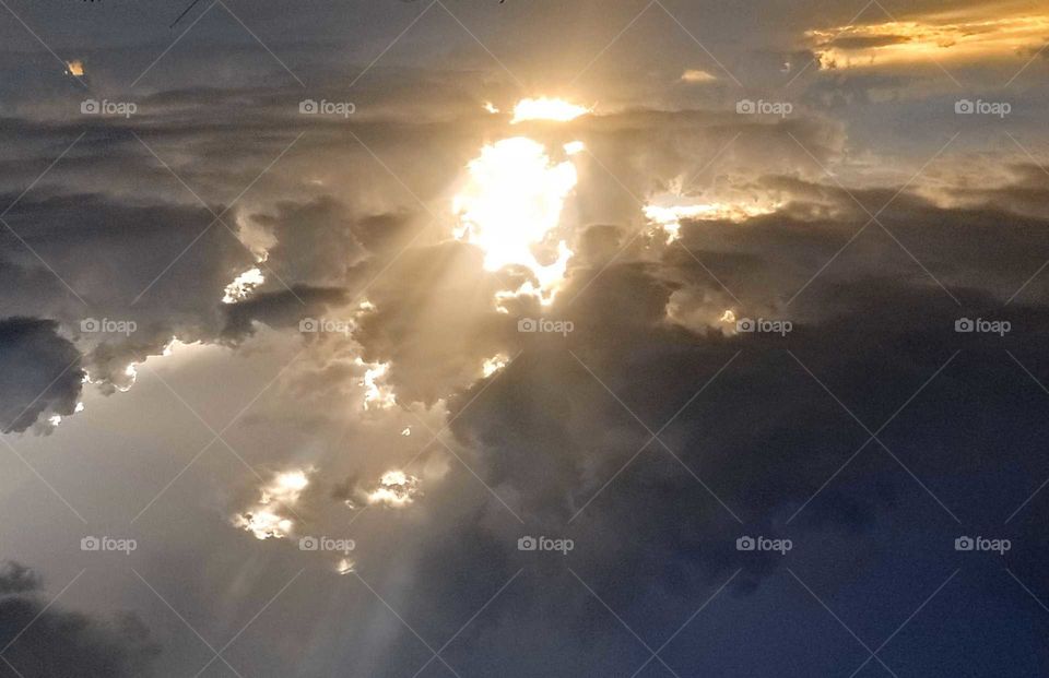 the sky outside my apartment before it rained today and the clouds swallowed the sun..