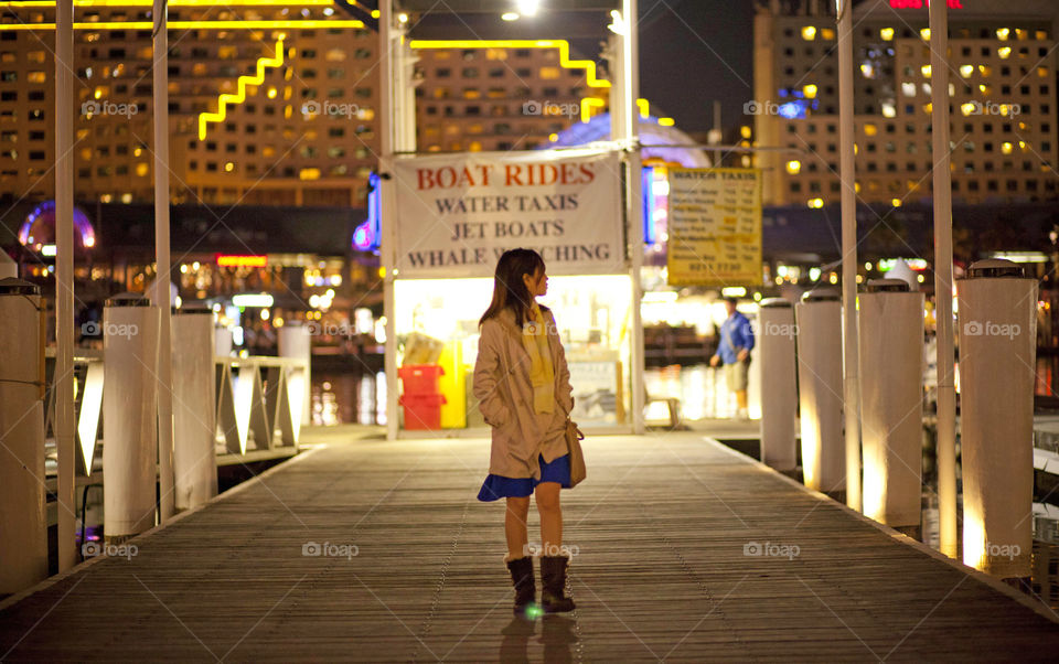 Lady exploring Australia Darling Harbour at night, Sydney, NSW