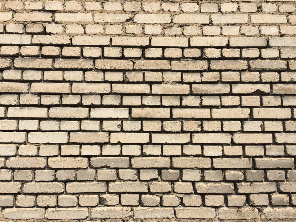 Beige brick wall texture with brick tiles