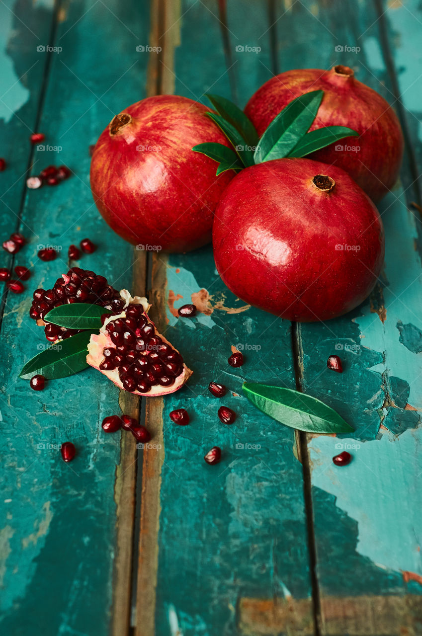 Ripe pomegranate fruit on wooden background