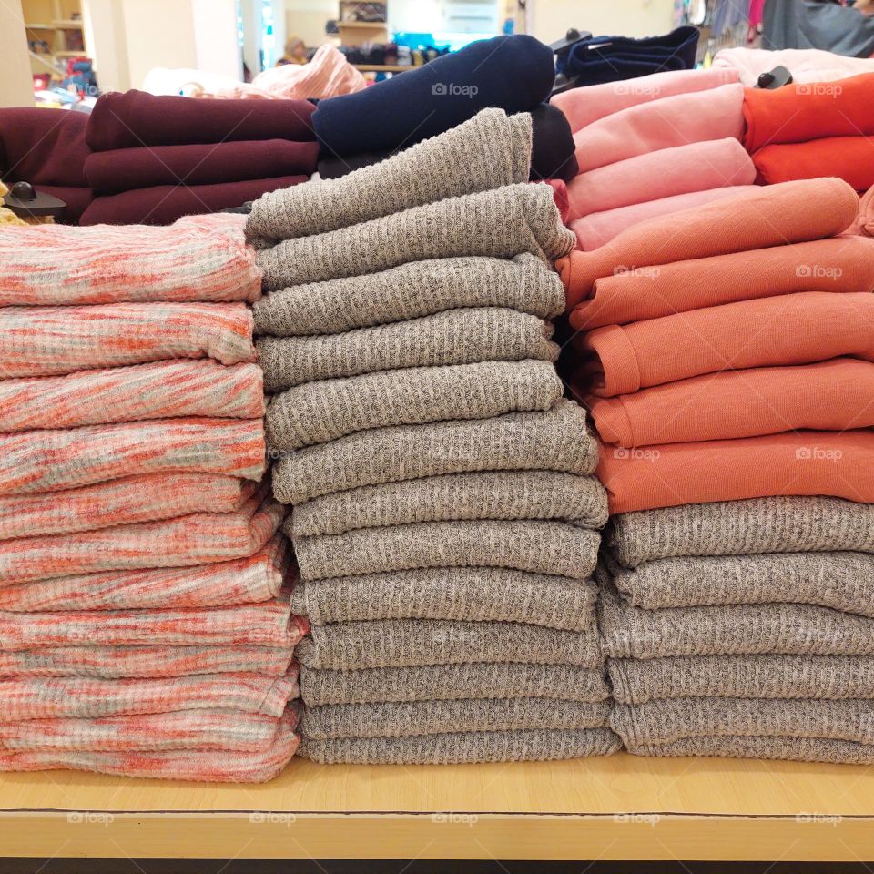 stacks of clothes folded neatly to attract shoppers