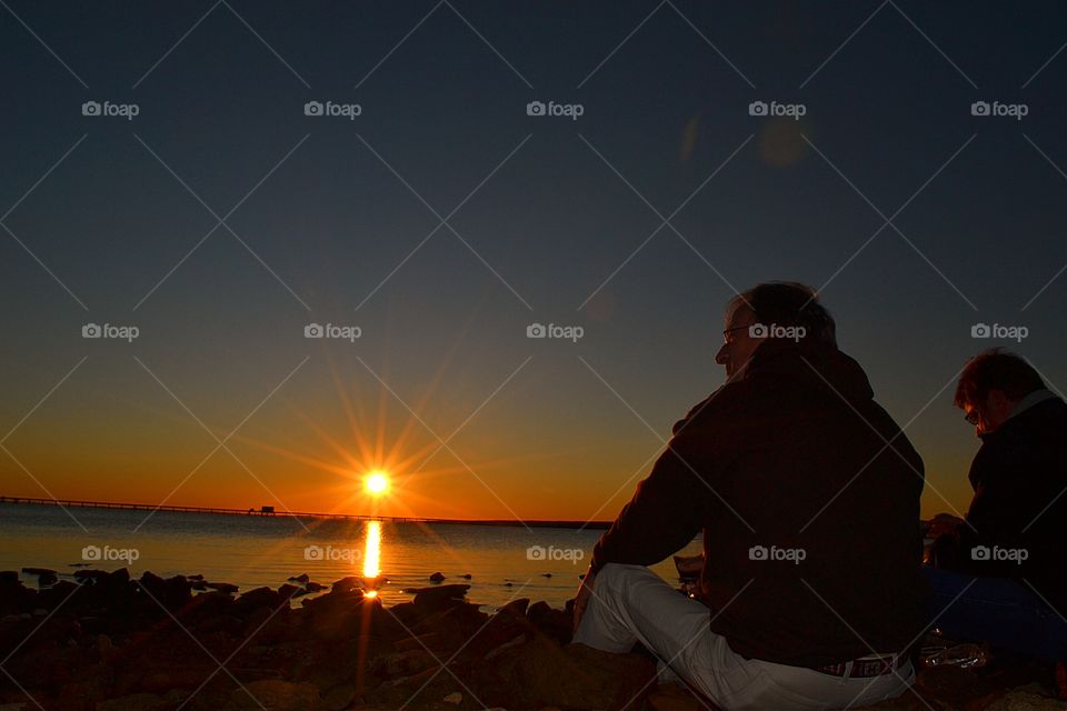 Enjoying the ocean sunset . Man Enjoying the ocean sunset in Oz