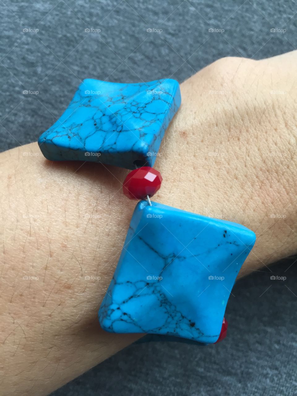 This bracelet is a combination of a favorite color combination: turquoise and deep red. I used simulated turquoise diamond-shaped beads, which are complimented by deep red faceted glass beads.