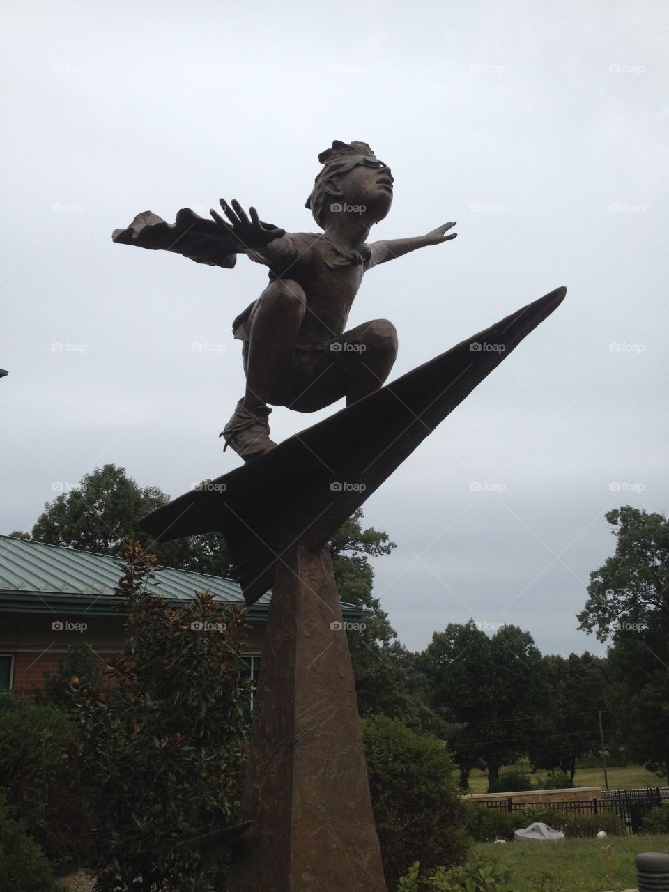 Sculpture of a child flying