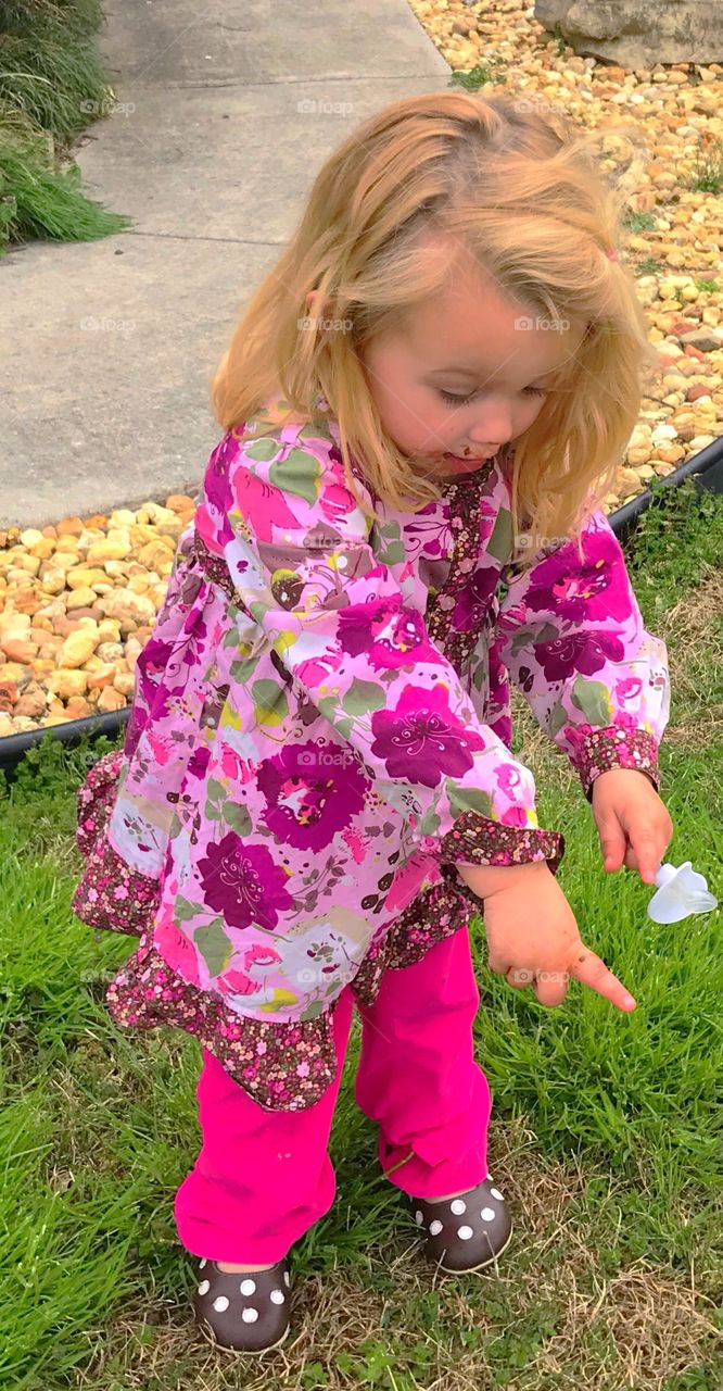 Little girl (toddler) hunting eggs on Easter, excited, 