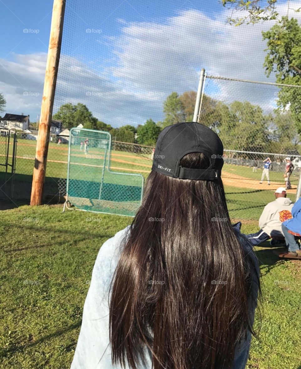 Messy hair watching baseball