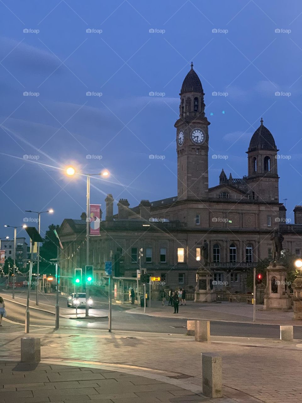 Evening city with ancient architecture in the form of a castle with a tower and a clock