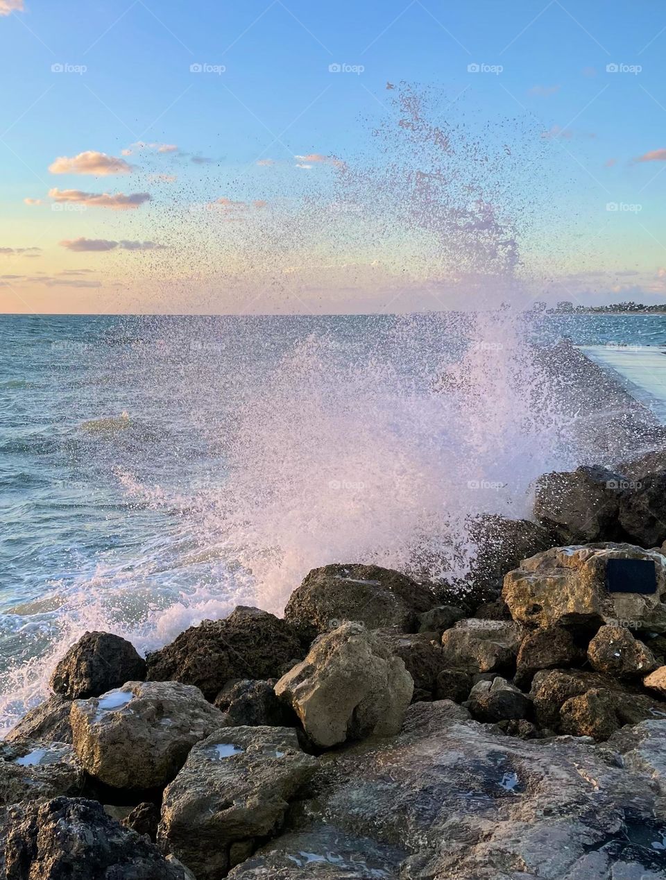 Waves crashing on the jetty rocks