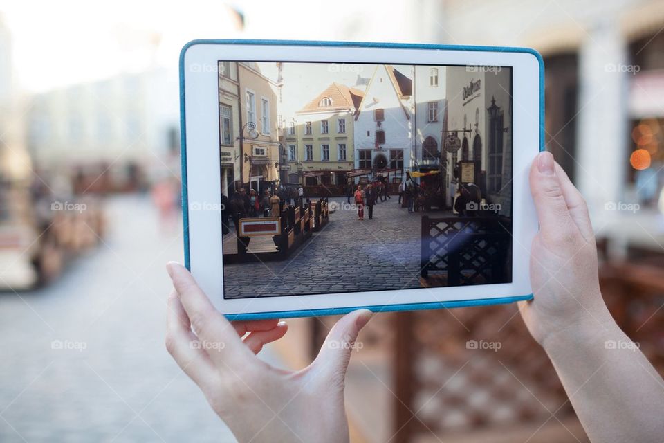 Person photographing with ipad on street