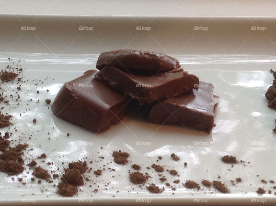 Pieces of fudge with cocoa powder.