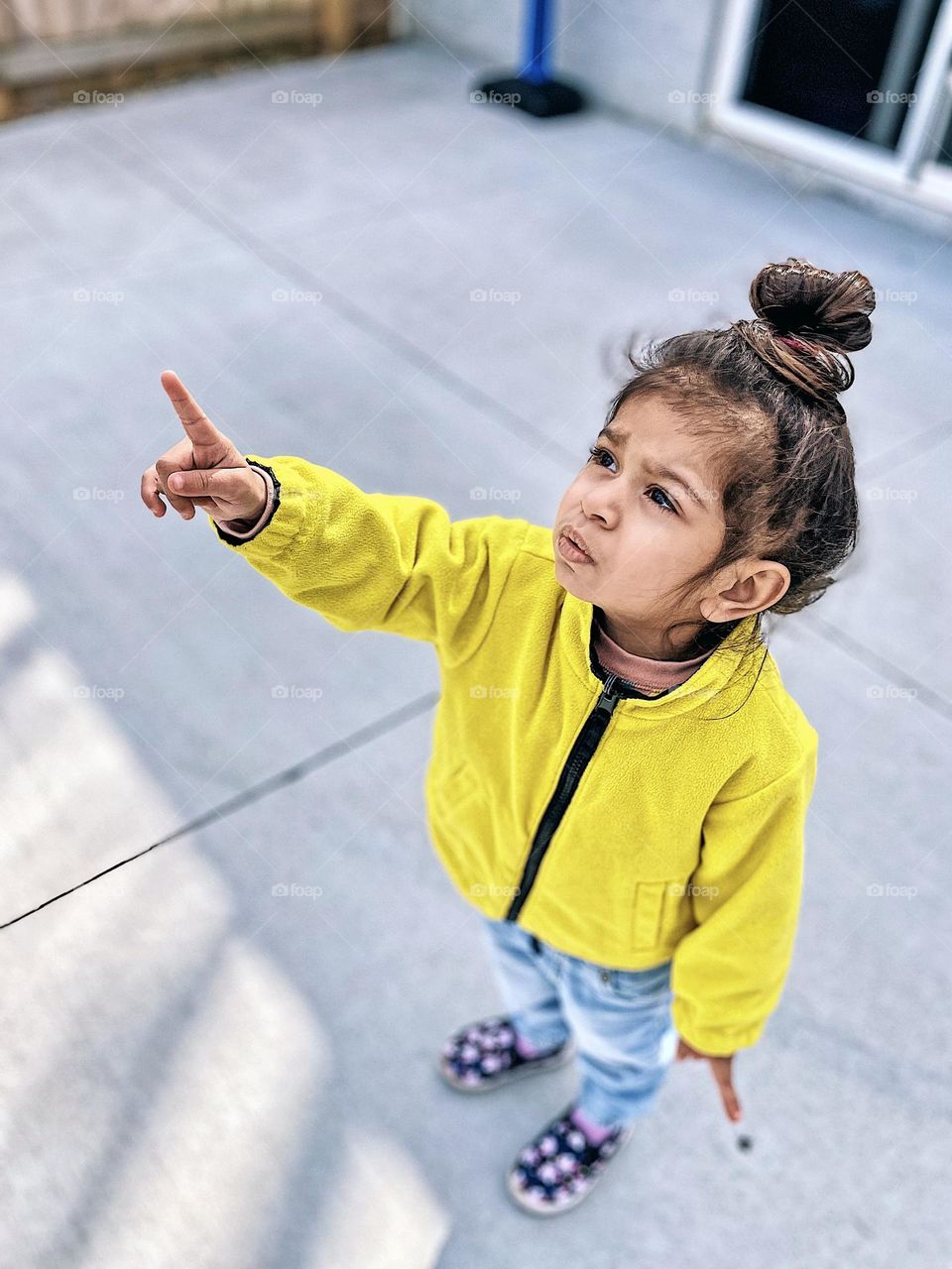 Toddler girl points up towards planes and birds, bird watching toddler, toddler loves planes and birds, looking to the sky and pointing, pointing at planes, perspective of a mother 